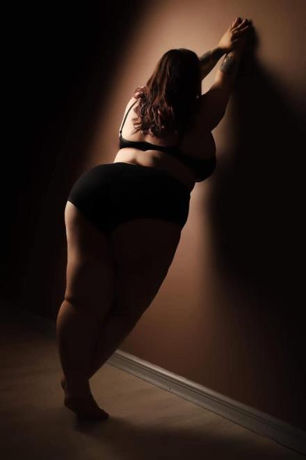 Athena Witch stands with her big ass to camera on a photoshoot