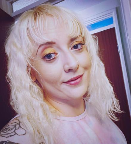 UK Cam girl Aubrey Sky takes a headshot selfie in a door way