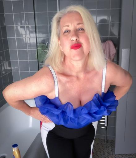 Mature blonde Maggie Moon poses in her bathroom