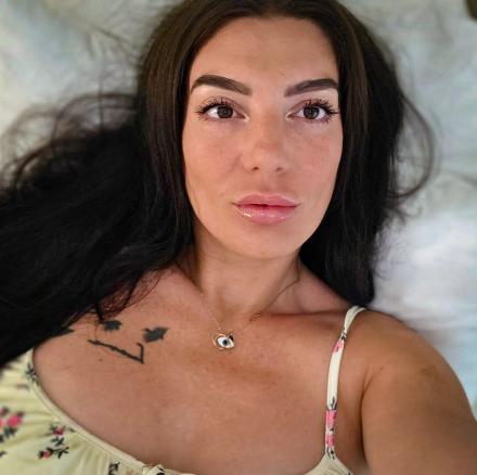 Mia Rosea takes a selfie laying in her bed