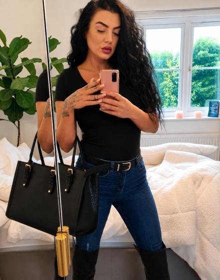 British webcam model Mia Rosea takes a full length shot of herself in the mirror wearing blue jeans and black top