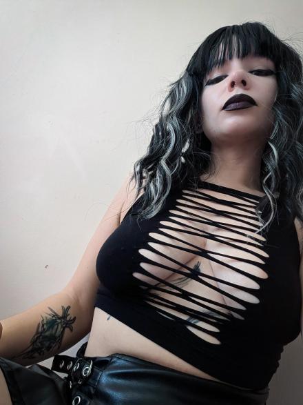 Opal takes a selfie wearing a black stringy top