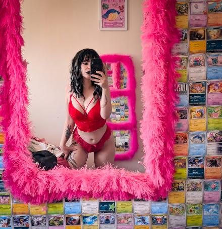UK cam model Opal takes a selfie in a fluffy pink-rimmed mirror wearing red lingerie
