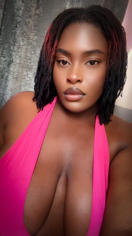 Oshun Waters shows off her huge natural tits while wearing a pink top in a selfie