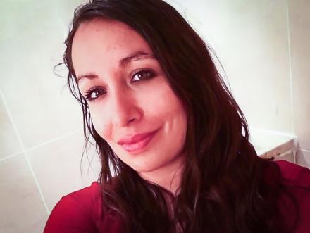 Headshot selfie of Rosa Freya wearing a red top
