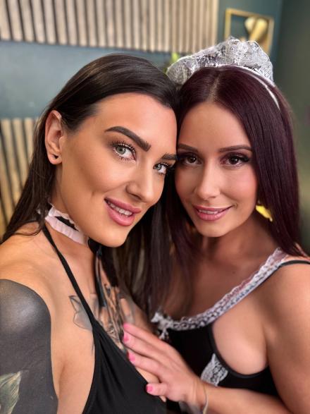 Belle O'Hara and Ginny Slayed posing together in a maids costume Belle O'Hara and Ginny Slayed posing together in a maids costume