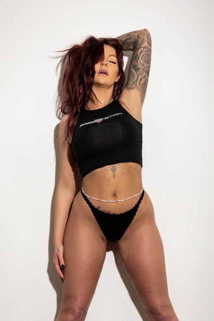 Zoe Grey posing with her arms lifted behind her head Zoe Grey posing with her arms lifted behind her head